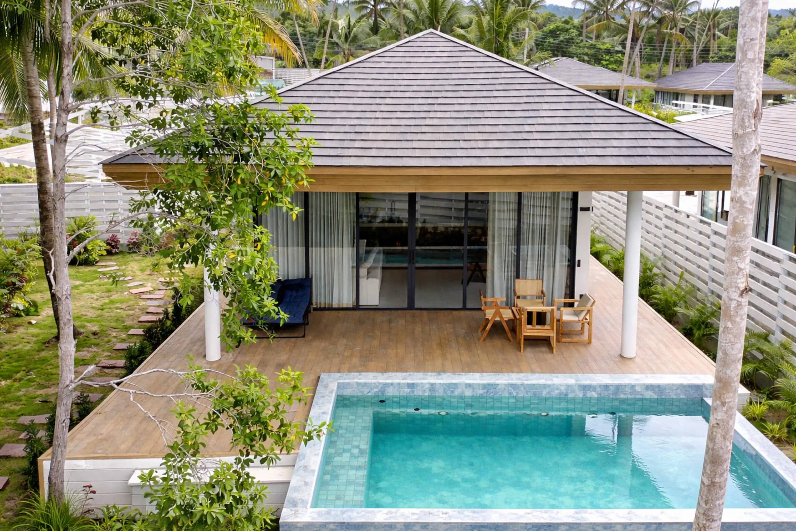White Lotus Villa II — the villa, pool and green hills behind
